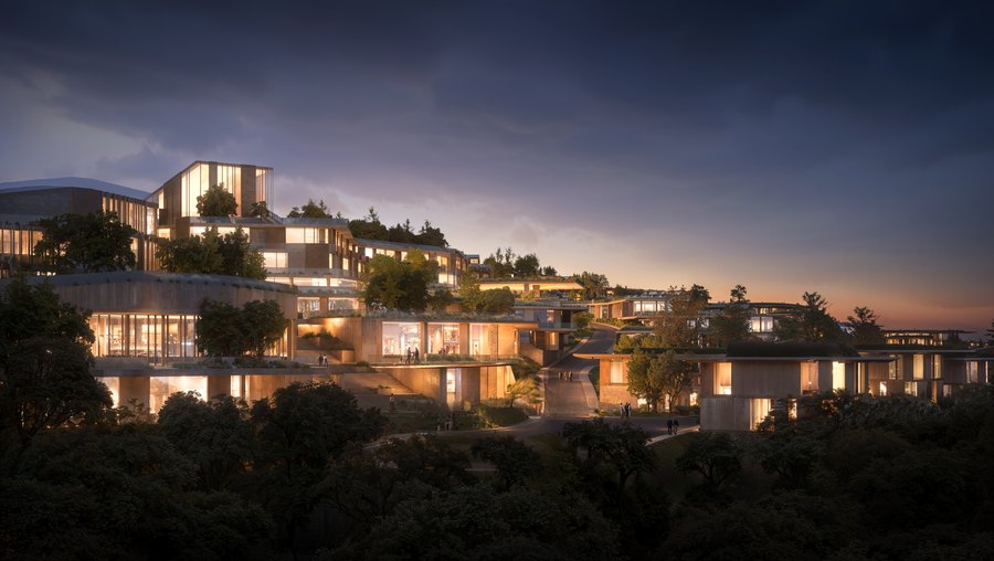 Residences at Mira Verde with the lights on at dusk